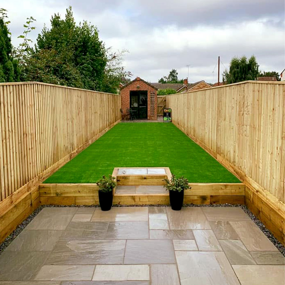 A landscaped garden featuring new fencing, artificial grass and a patio by DH Landscapes