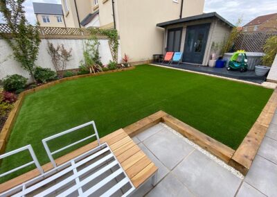 A raised section of artificial grass surrounded by wooden trim