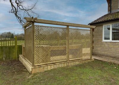 A wooden garden structure on a deck