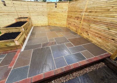 Dark patio with step up and brick detail surrounding the area